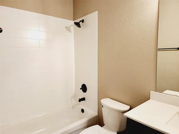 a bathroom with a toilet and a bathtub