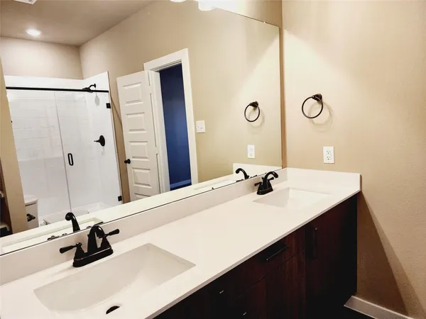a bathroom with a sink vanity and a mirror