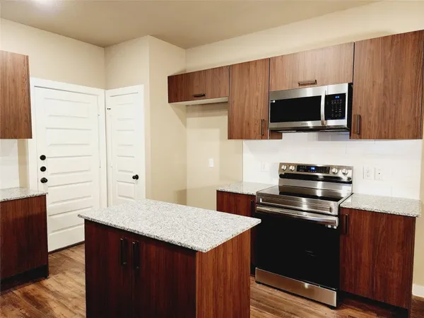 a kitchen with a cabinets and steel appliances