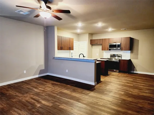 a kitchen with stainless steel appliances granite countertop a sink and cabinets