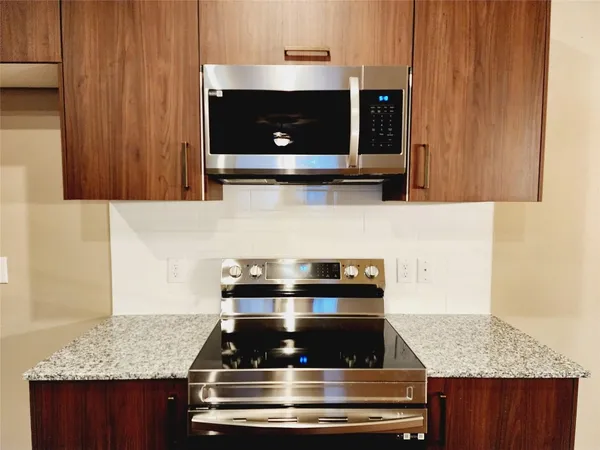 a stove top oven sitting inside of a kitchen