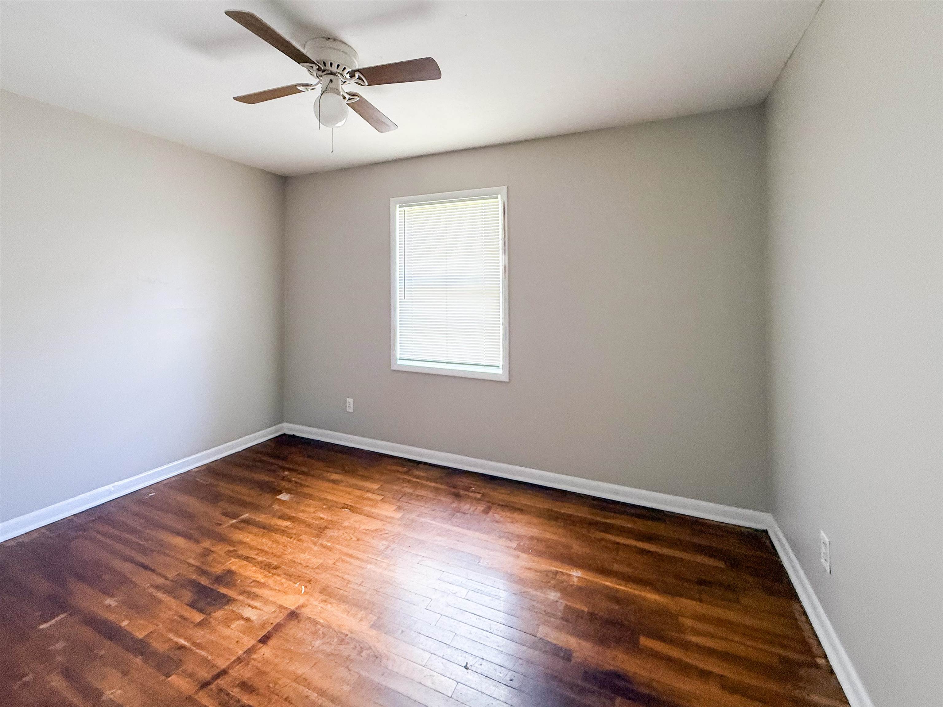 655 West Raines Road Memphis, TN 38109 - Photo 14 of 18 Spare room with dark wood-style flooring and a ceiling fan