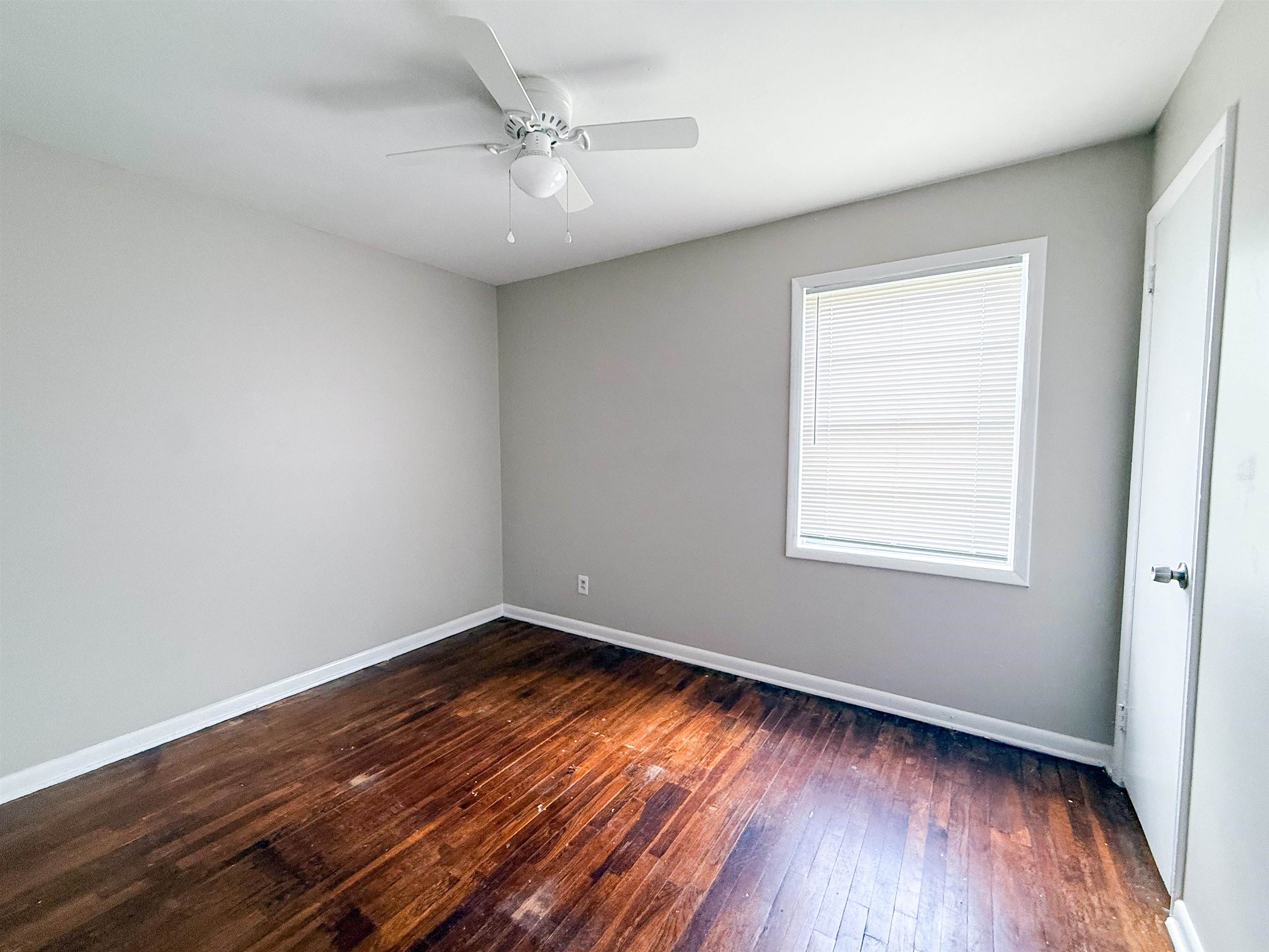 655 West Raines Road Memphis, TN 38109 - Photo 15 of 18 Spare room with dark wood-style flooring and a ceiling fan