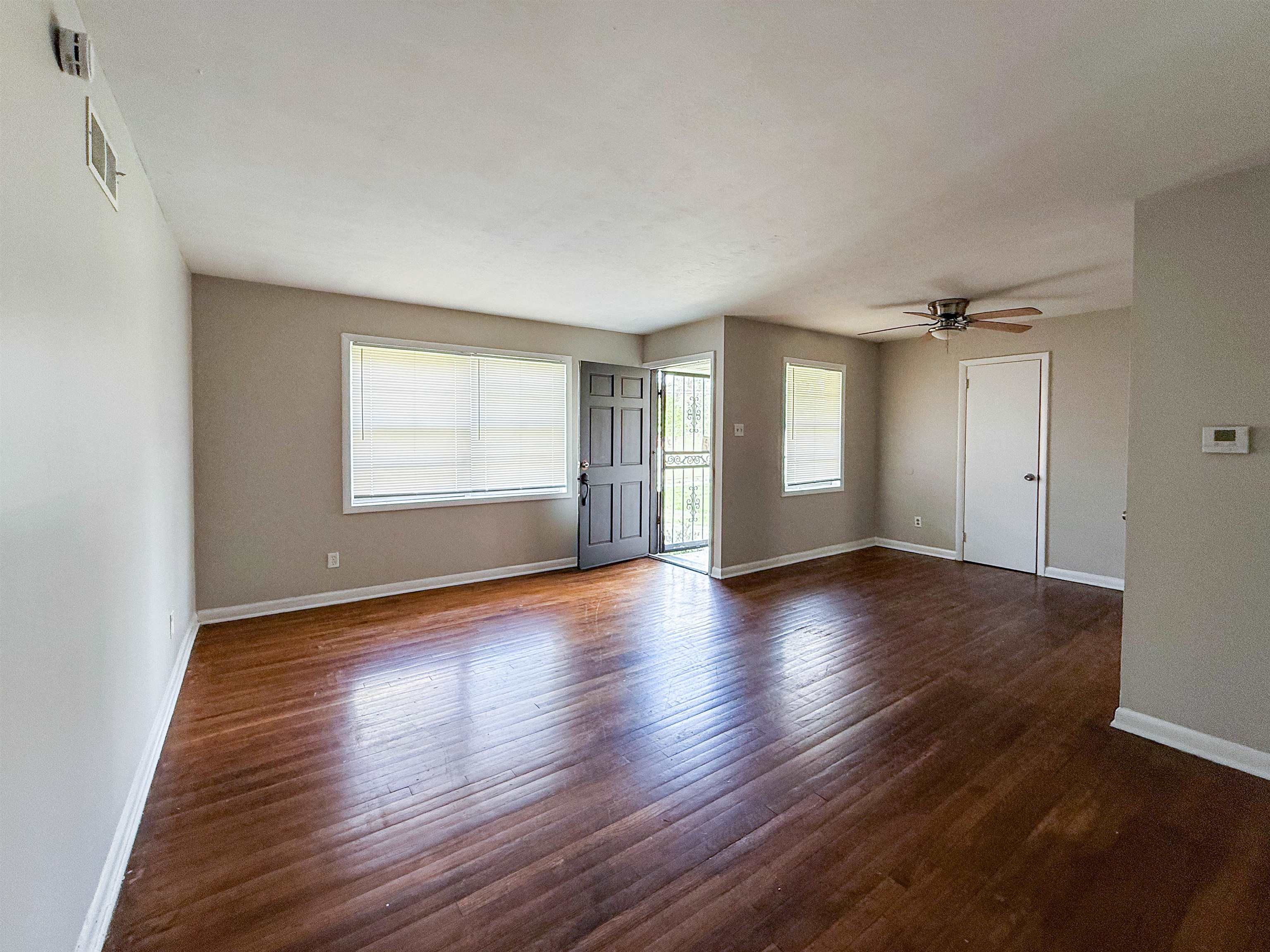 655 West Raines Road Memphis, TN 38109 - Photo 5 of 18 Empty room featuring dark wood-style flooring and a ceiling fan