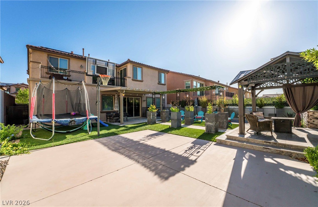 2787 Athens Ridge Drive Henderson, NV 89052 - Photo 29 of 31 A private backyard oasis features artificial turf, concrete patio, and a charming gazebo, perfect for outdoor enjoyment.