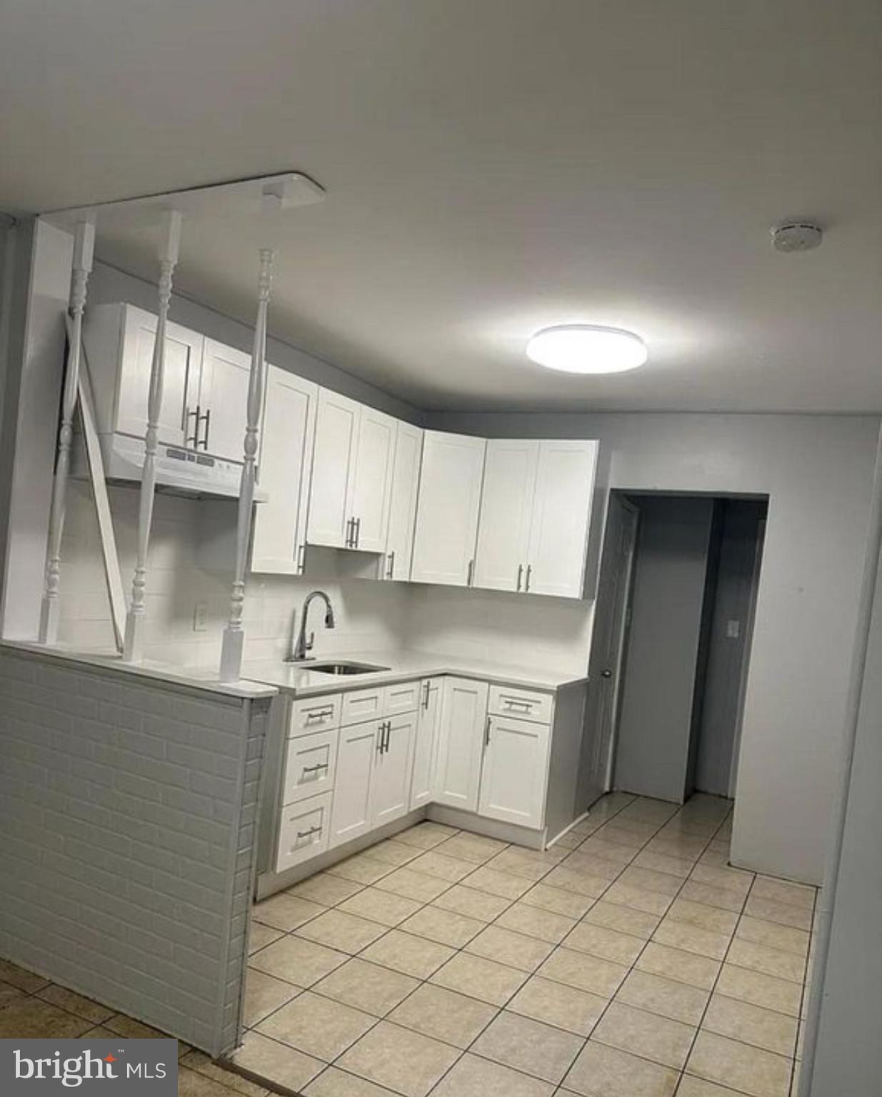 a kitchen with granite countertop white cabinets and white appliances