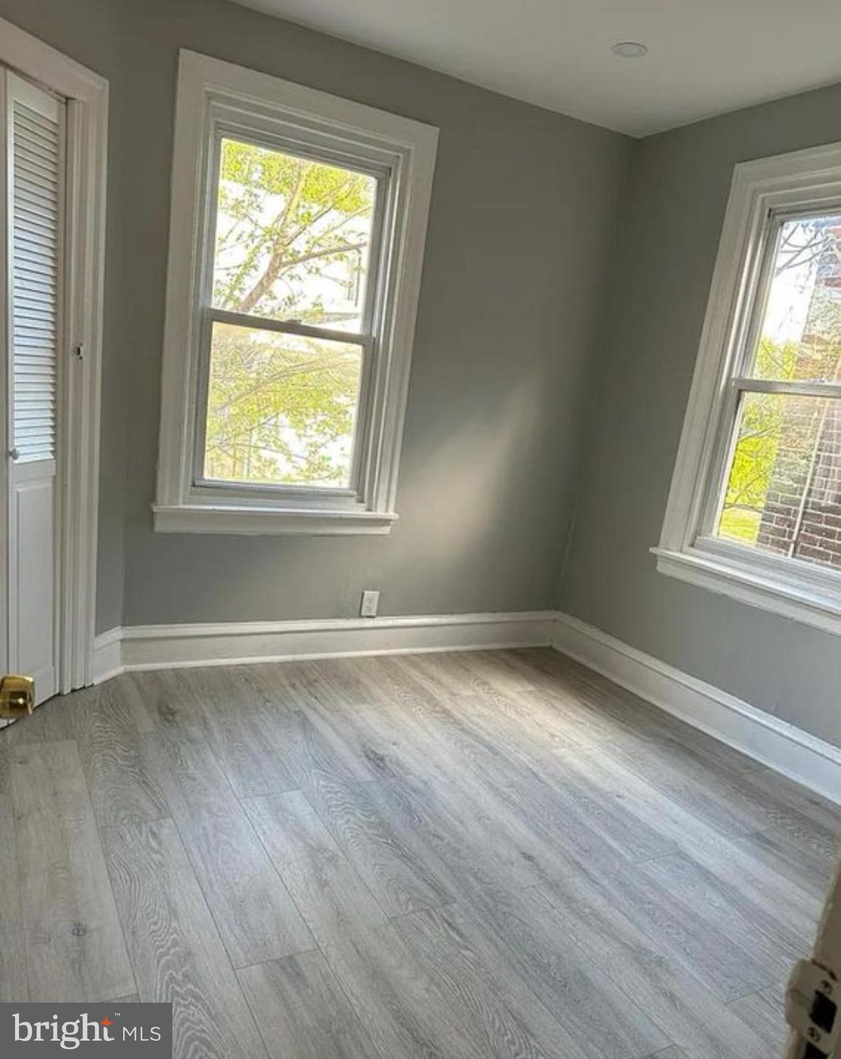 6550 Regent Street Philadelphia, PA 19142 - Photo 6 of 12 an empty room with wooden floor and windows