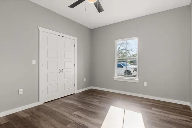 an empty room with windows and closet