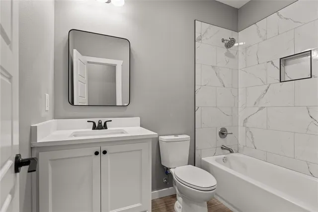 a bathroom with a toilet sink and mirror