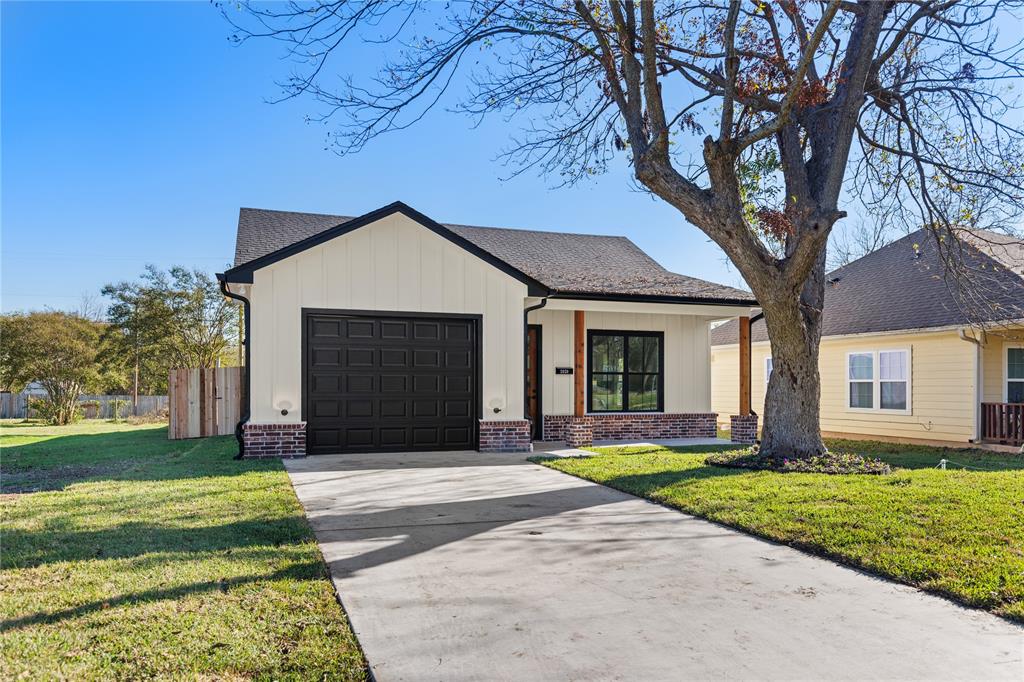 2020 Bosque Boulevard Waco, TX 76707 - Photo 25 of 27 a front view of a house with a yard and garage