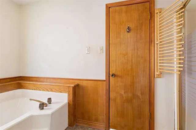 a bathroom with a tub and a window