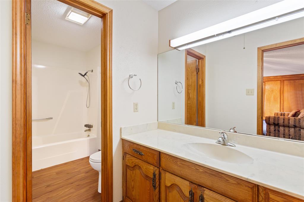 649 Highway 84 Fairfield, TX 75840 - Photo 22 of 39 a bathroom with a granite countertop sink and a mirror