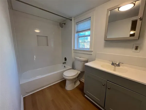 a bathroom with a sink a toilet and bathtub