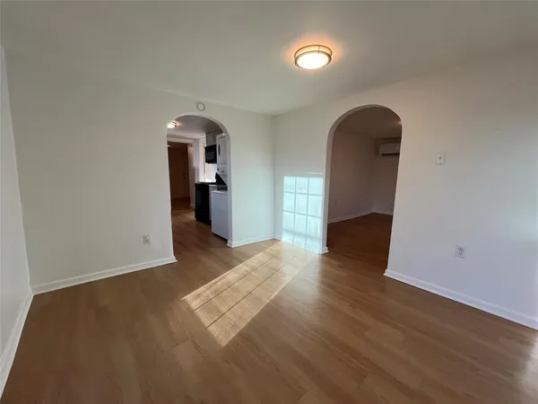wooden floor in an empty room with a window