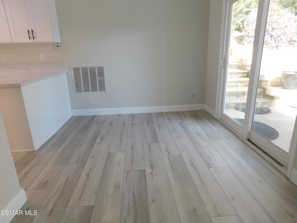 559 Stoney Peak Court Simi Valley, CA 93065 - Photo 19 of 62 a view of wooden floor and windows in a kitchen