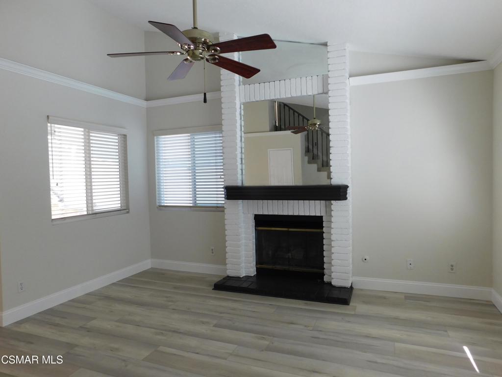559 Stoney Peak Court Simi Valley, CA 93065 - Photo 21 of 62 a view of an empty room with wooden floor fireplace and a window