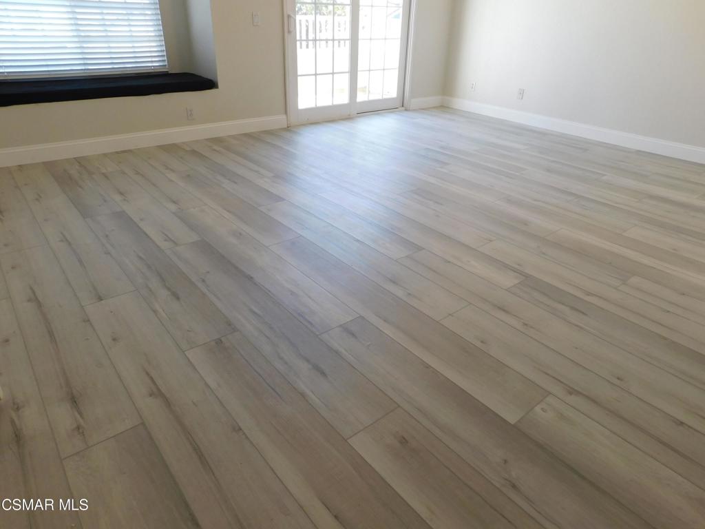 559 Stoney Peak Court Simi Valley, CA 93065 - Photo 26 of 62 an empty room with wooden floor and windows