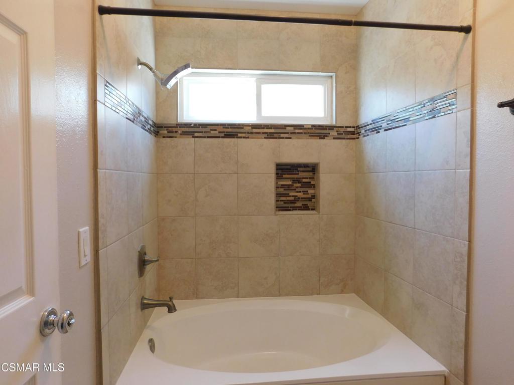 559 Stoney Peak Court Simi Valley, CA 93065 - Photo 31 of 62 a bathroom with a bathtub and shower