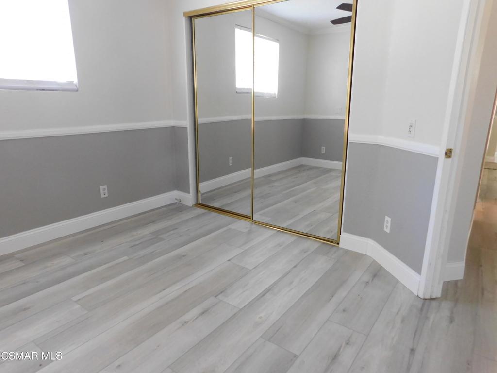 559 Stoney Peak Court Simi Valley, CA 93065 - Photo 36 of 62 an empty room with wooden floor and windows