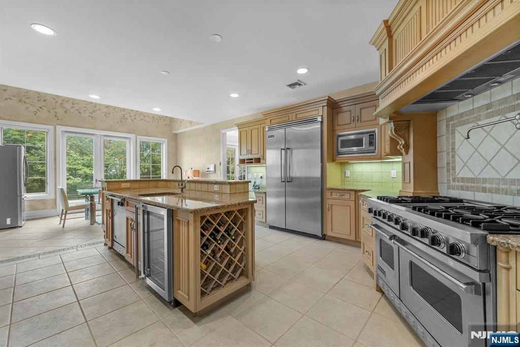 1 Euclid Road Fort Lee, NJ 07024 - Photo 11 of 50 a kitchen with stainless steel appliances granite countertop a stove and a sink