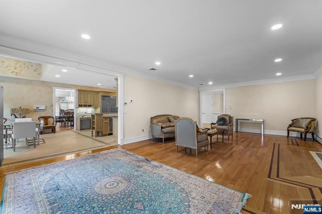 1 Euclid Road Fort Lee, NJ 07024 - Photo 22 of 50 a living room with furniture a table and kitchen view