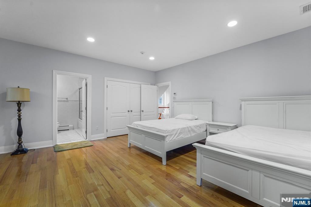 1 Euclid Road Fort Lee, NJ 07024 - Photo 32 of 50 a spacious bedroom with a bed and a cabinets