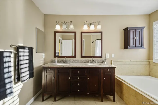a bathroom with a double vanity sink and a bathtub