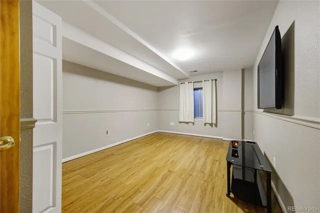 a view of a room with wooden floor and cabinet