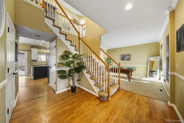 a view of entryway and hall with wooden floor
