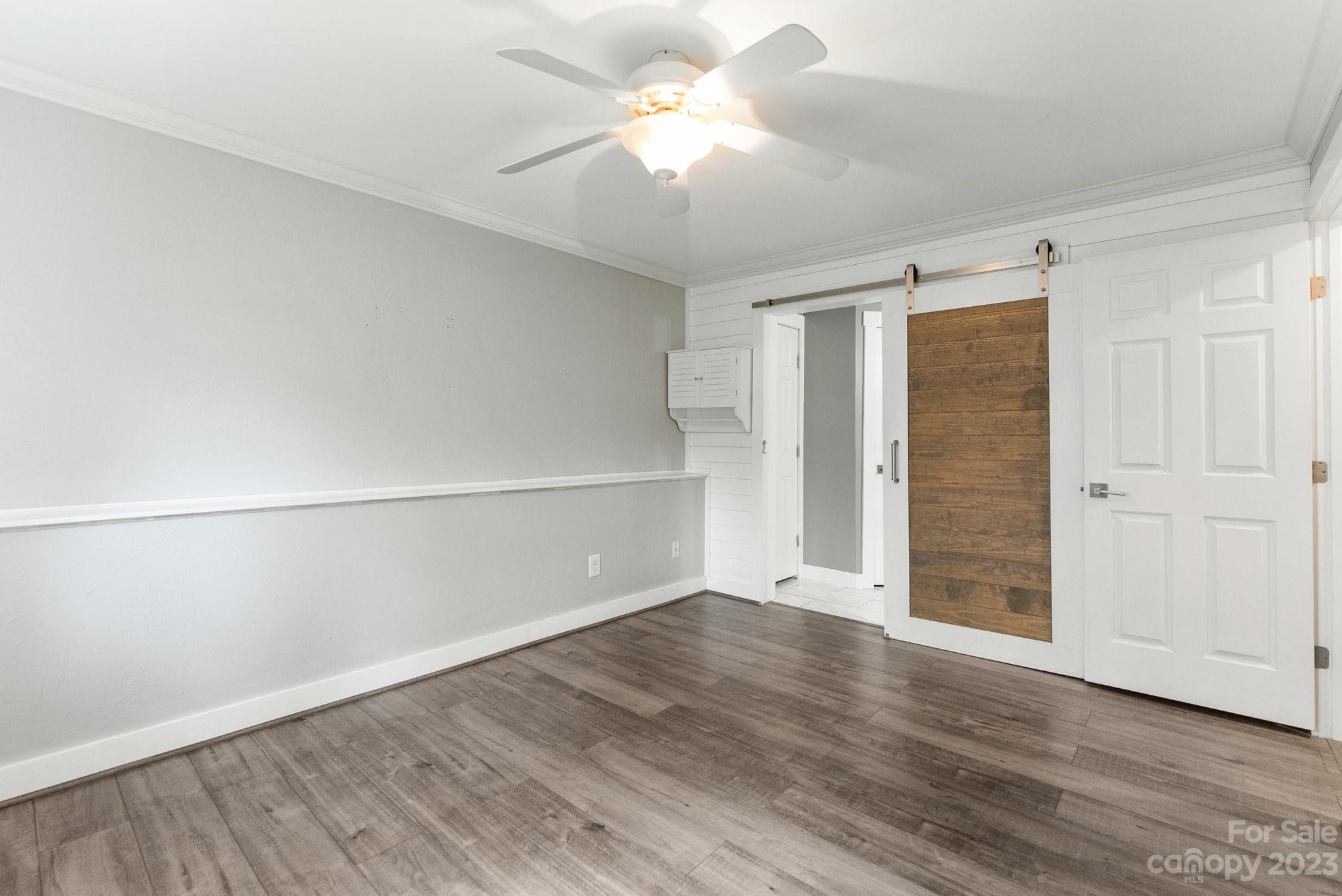 19905 Henderson Road, Unit A Cornelius, NC 28031 - Photo 11 of 46 an empty room with closet and a ceiling fan