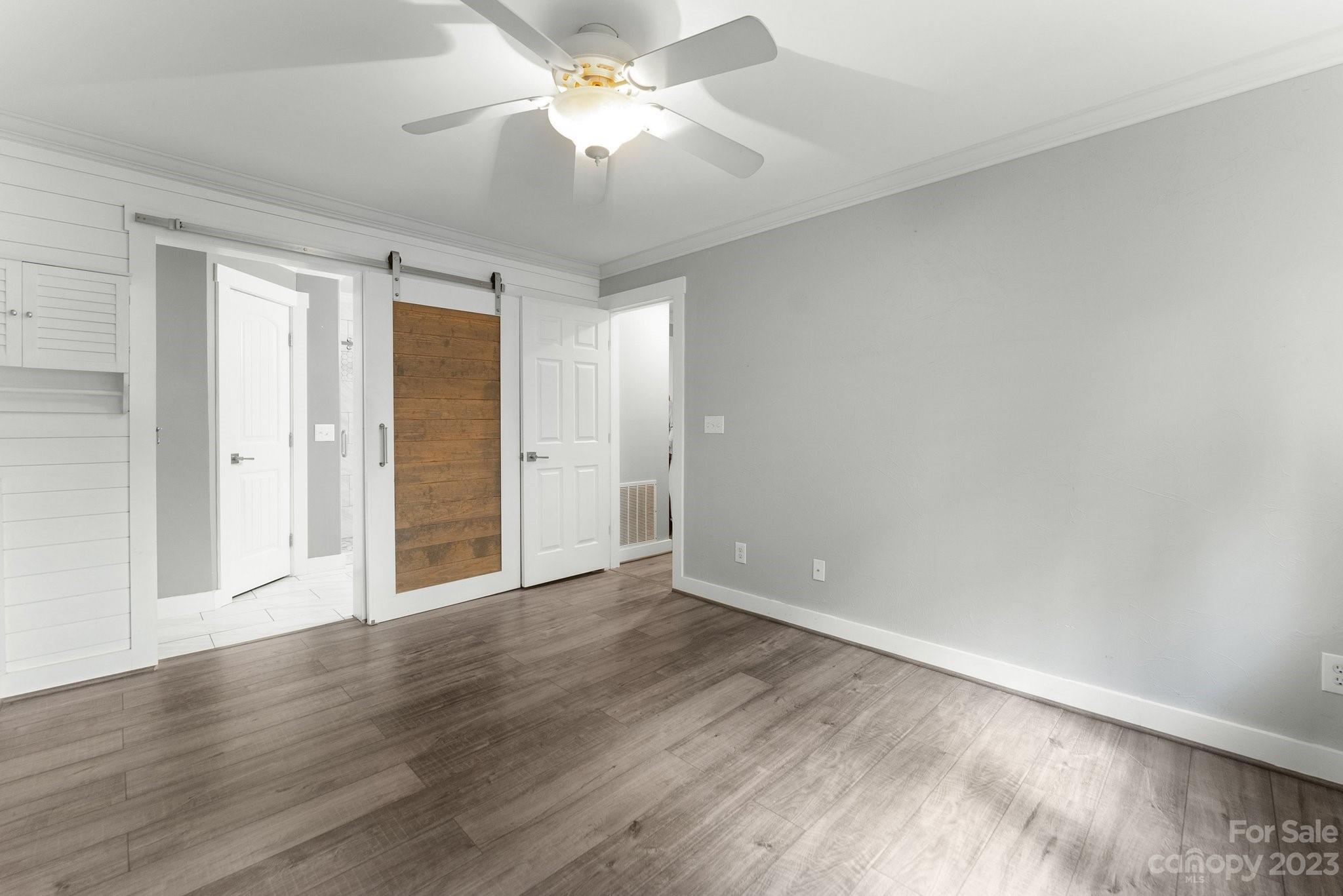 19905 Henderson Road, Unit A Cornelius, NC 28031 - Photo 12 of 46 a view of an empty room with wooden floor