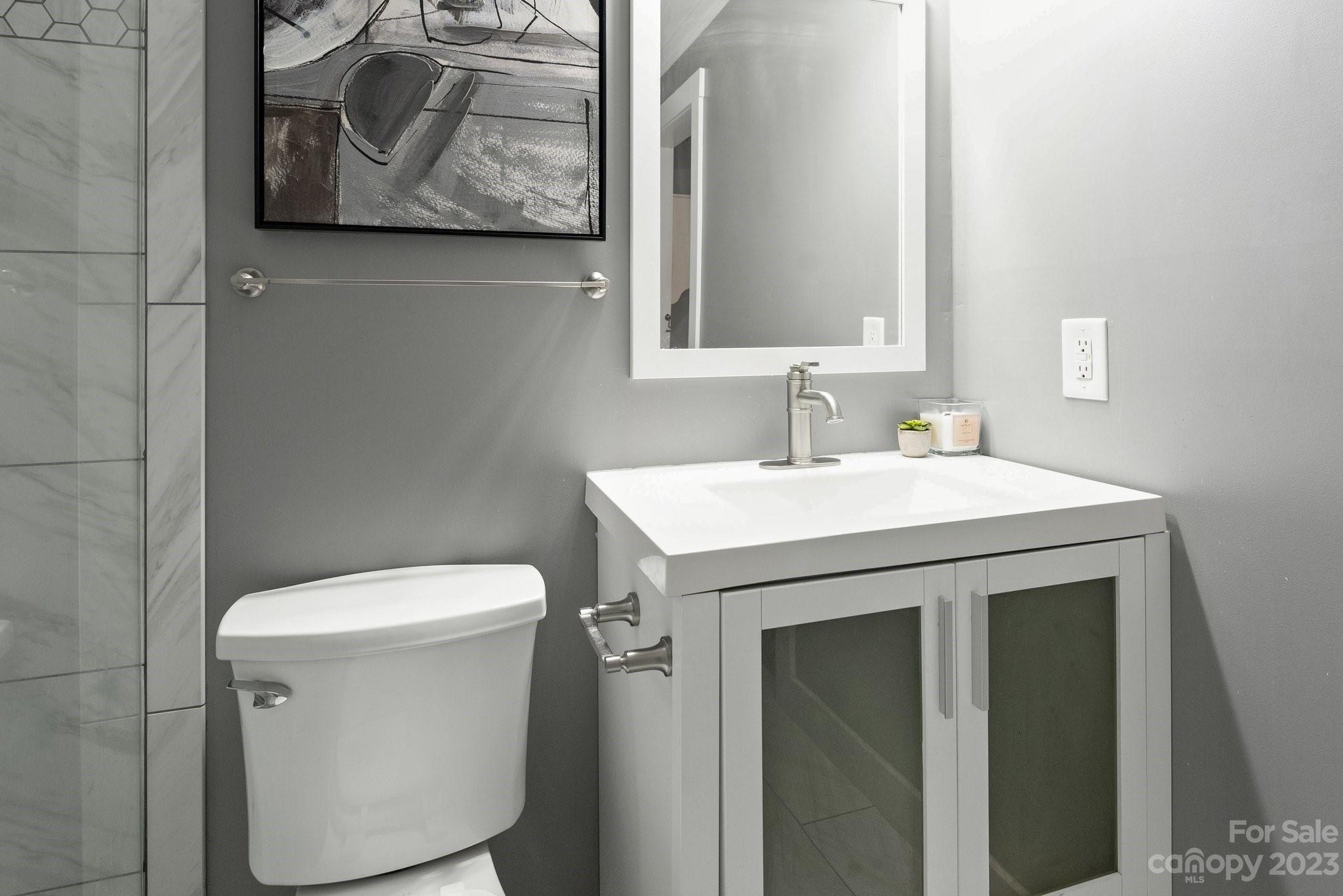 19905 Henderson Road, Unit A Cornelius, NC 28031 - Photo 14 of 46 a bathroom with a toilet sink and mirror