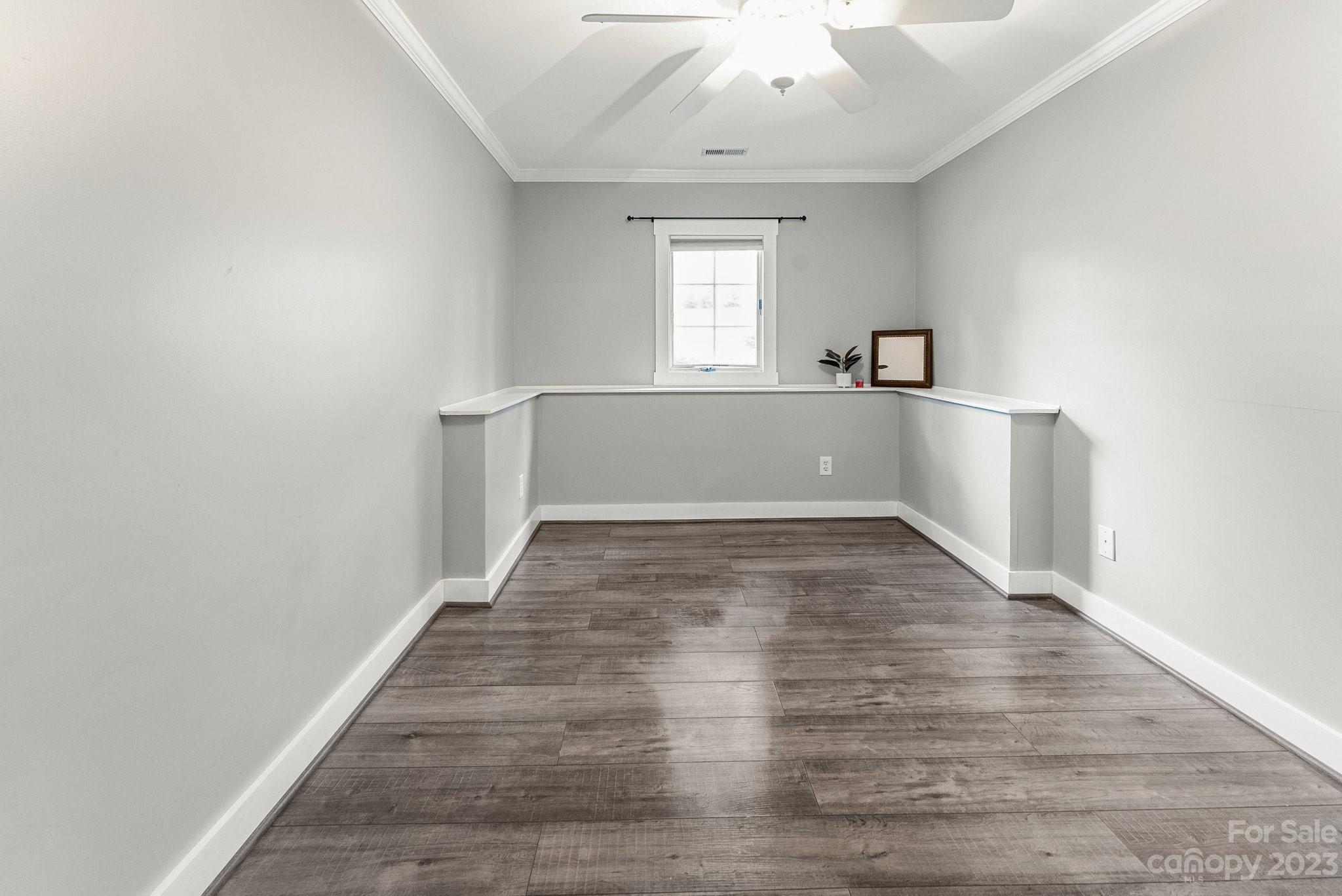 19905 Henderson Road, Unit A Cornelius, NC 28031 - Photo 18 of 46 a view of empty room with wooden floor and fan