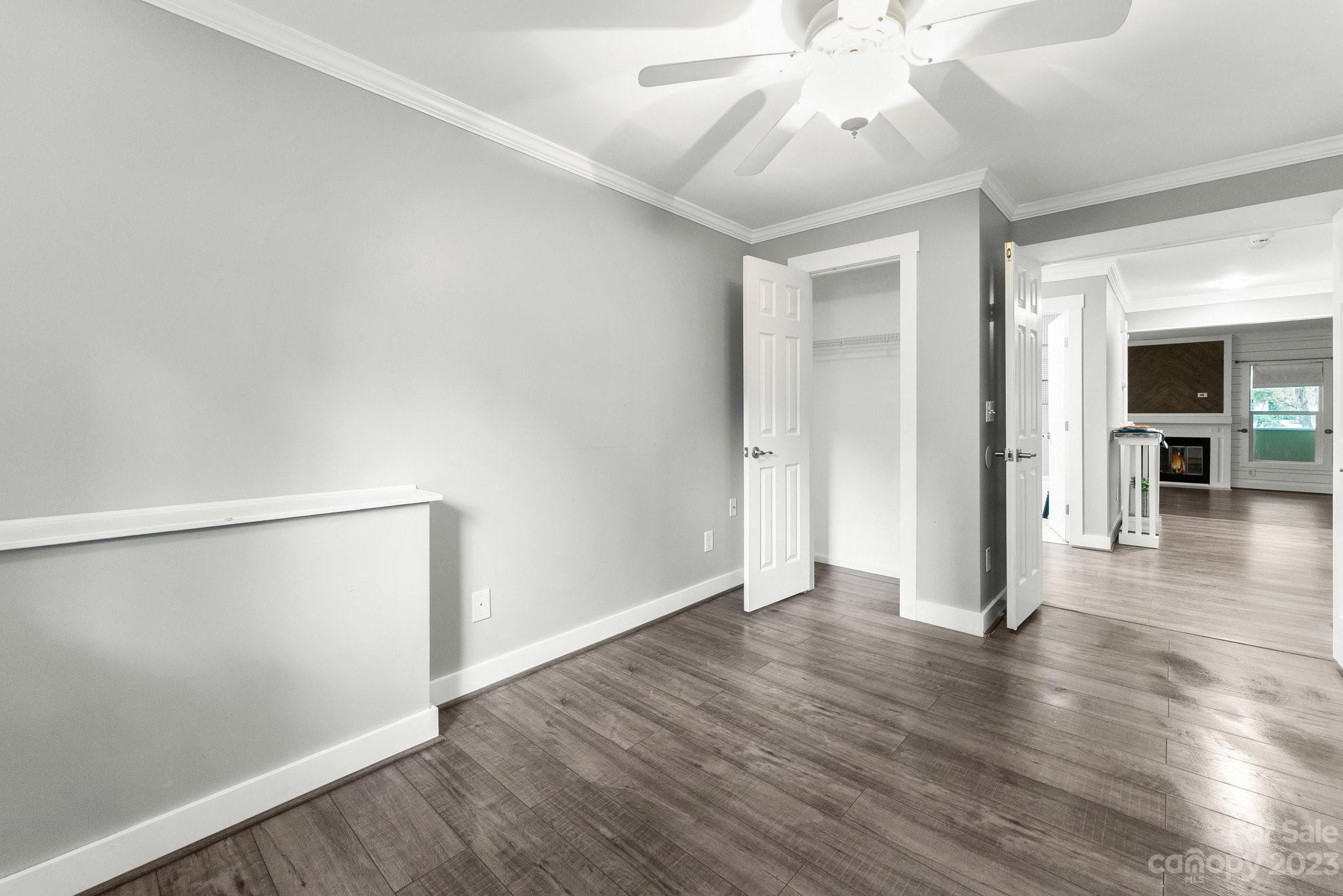 19905 Henderson Road, Unit A Cornelius, NC 28031 - Photo 19 of 46 an empty room with wooden floor and ceiling fan