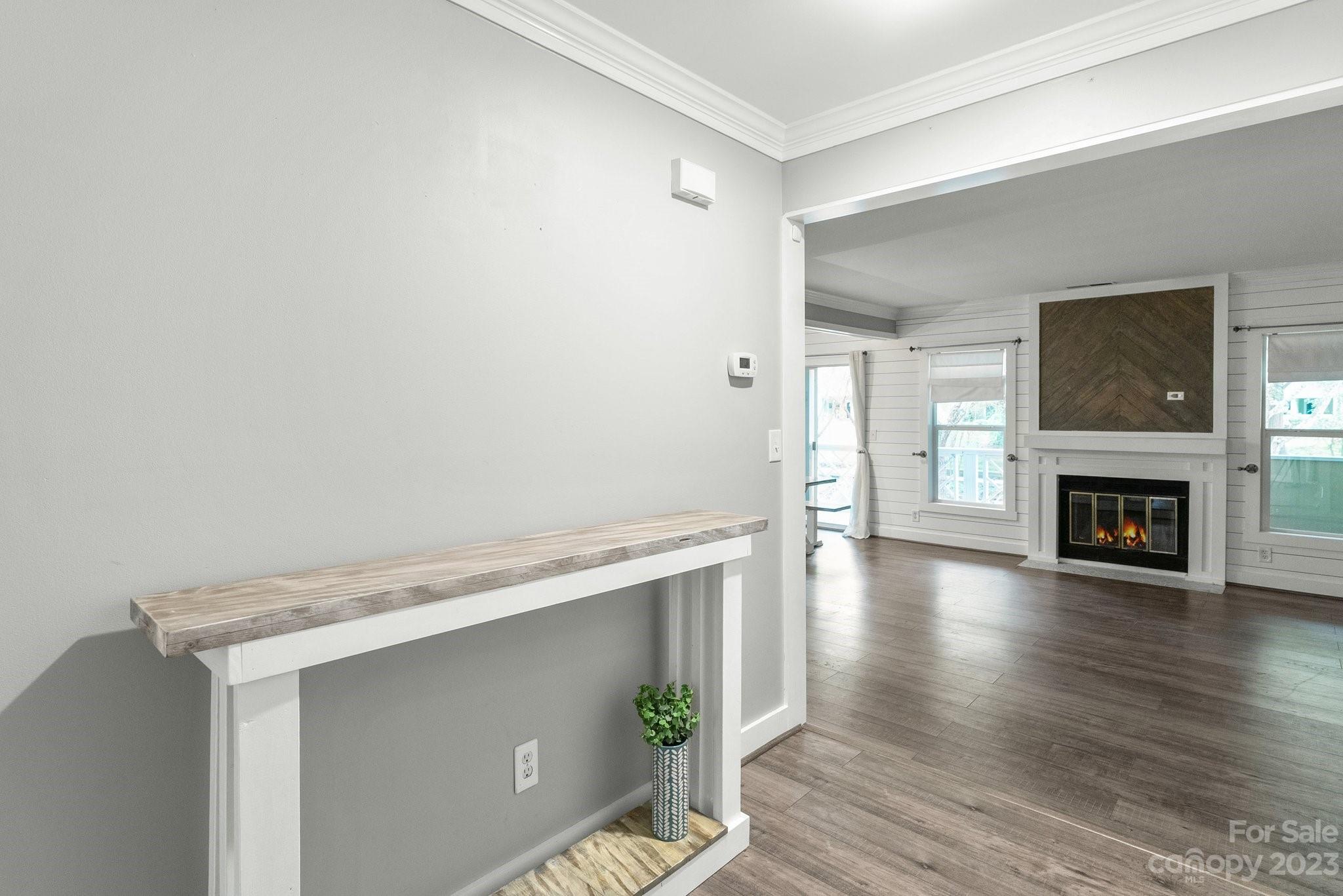 19905 Henderson Road, Unit A Cornelius, NC 28031 - Photo 2 of 46 a view of an empty room with wooden floor and a fireplace