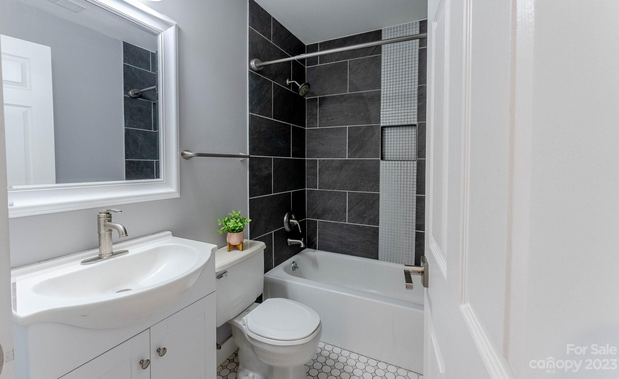 19905 Henderson Road, Unit A Cornelius, NC 28031 - Photo 22 of 46 a bathroom with a sink toilet and shower