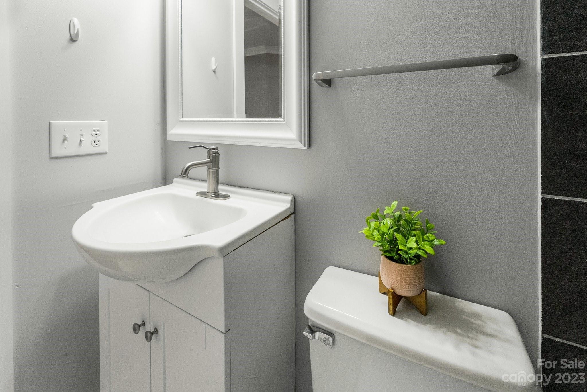 19905 Henderson Road, Unit A Cornelius, NC 28031 - Photo 25 of 46 a bathroom with a sink a toilet and a mirror