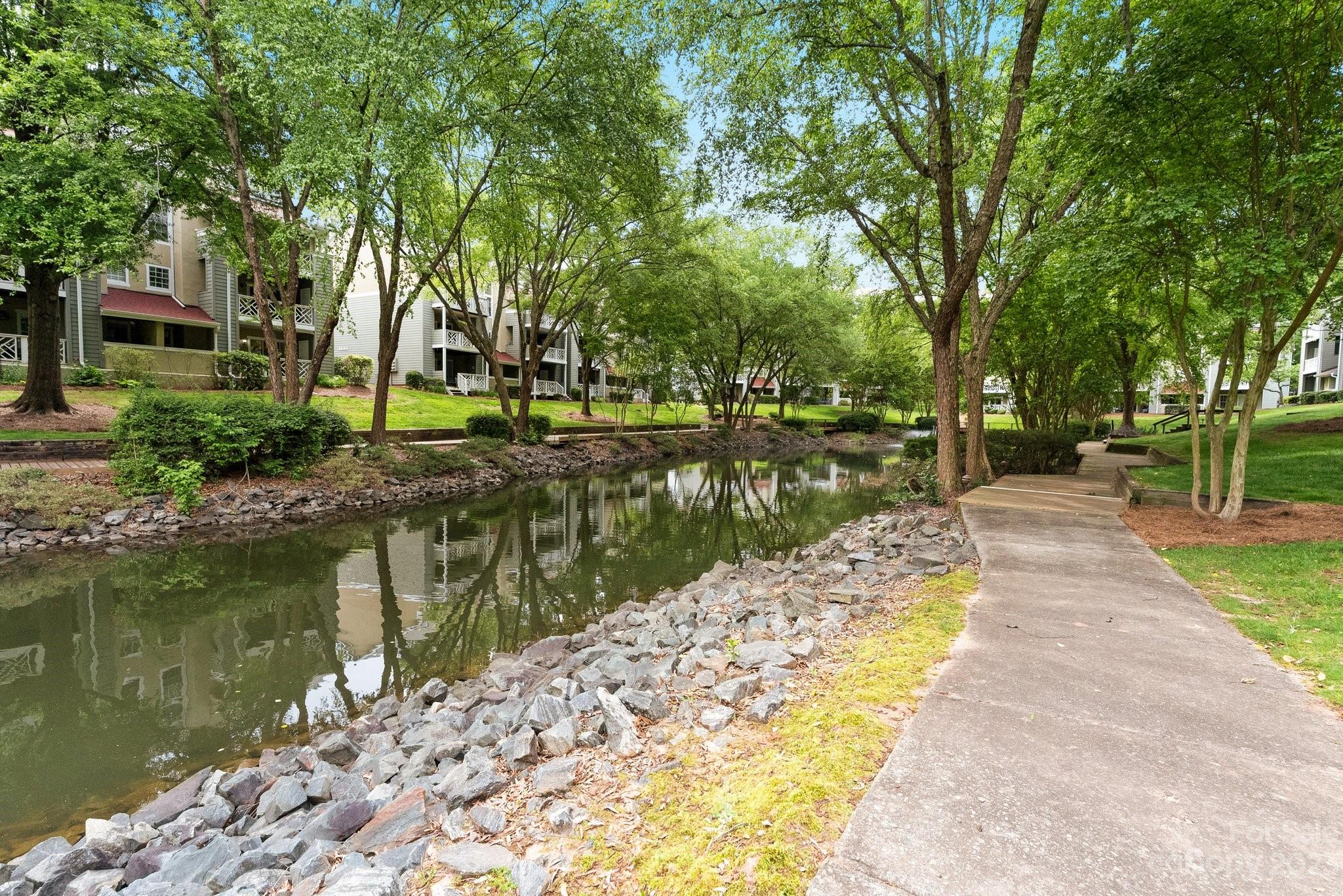 19905 Henderson Road, Unit A Cornelius, NC 28031 - Photo 33 of 46 a view of a lake with a house in the background