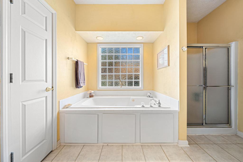 109 Sheldon Lane Westminster, SC 29693 - Photo 18 of 39 Relax in this inviting bathroom featuring a soaking tub and glass block window