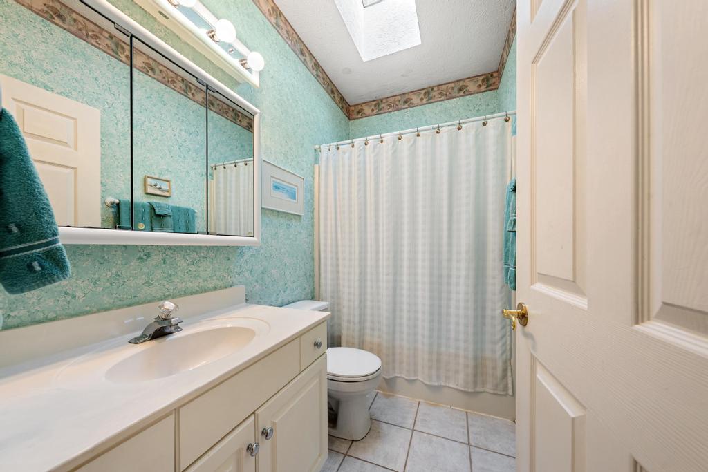 109 Sheldon Lane Westminster, SC 29693 - Photo 20 of 39 This bright bathroom features a spacious vanity, skylight, and tiled flooring.