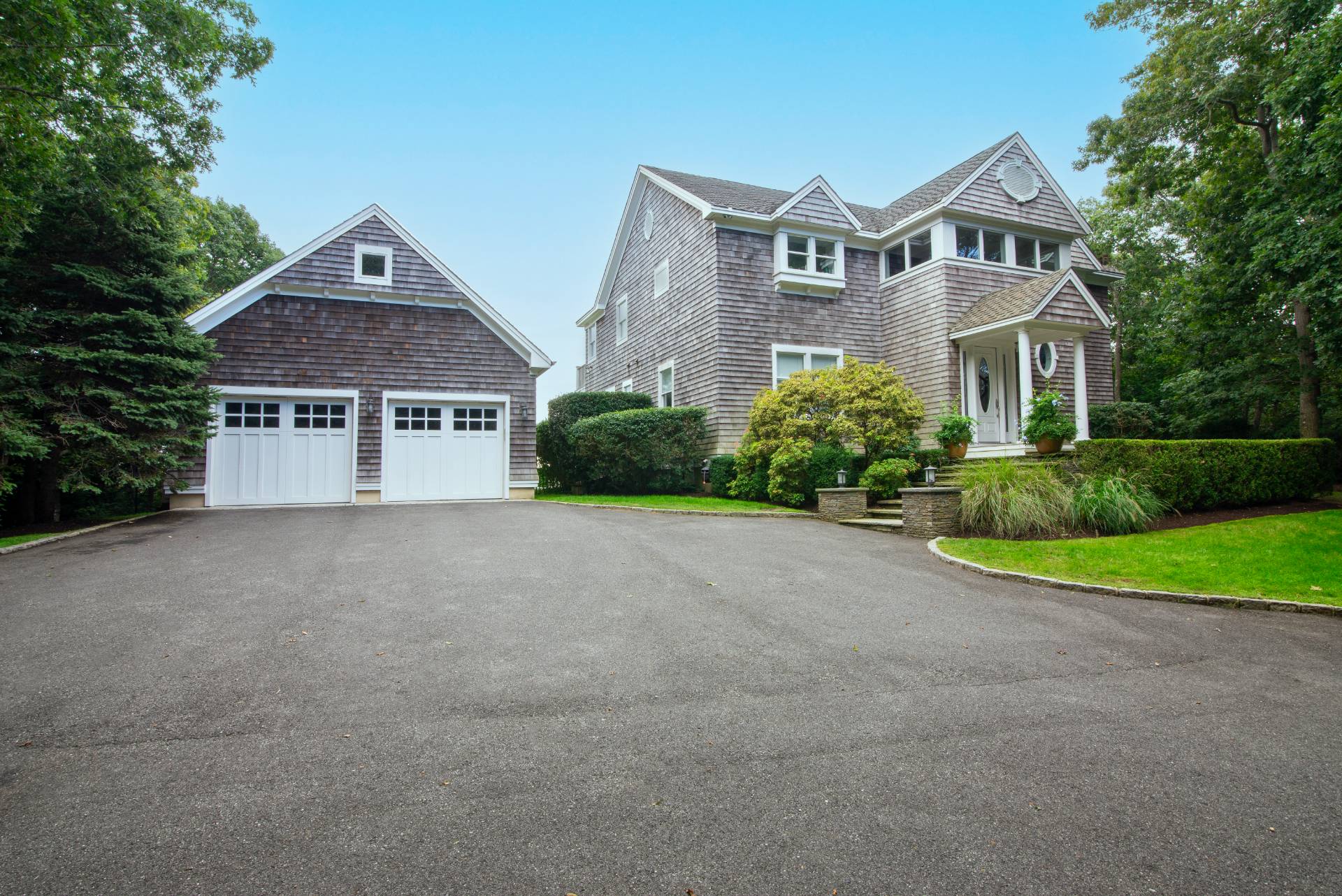 23 Sycamore Lane Montauk, NY 11954 - Photo 26 of 33 a front view of a house with a yard and garage