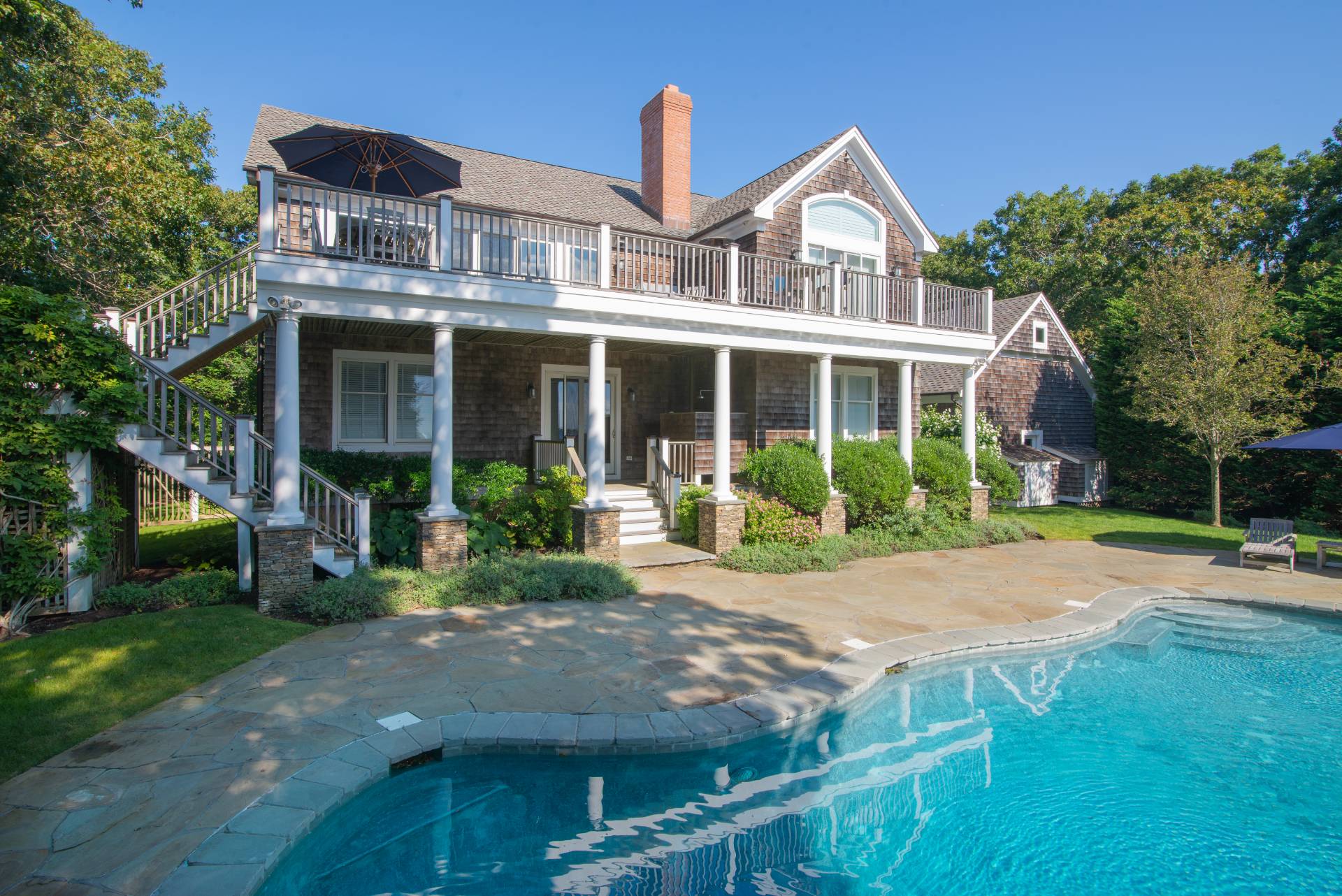 23 Sycamore Lane Montauk, NY 11954 - Photo 3 of 33 a front view of a house with porch and garden