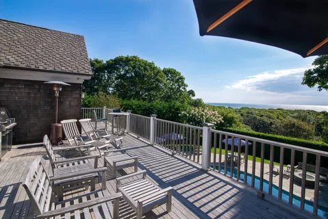a view of a patio with a table chairs and backyard