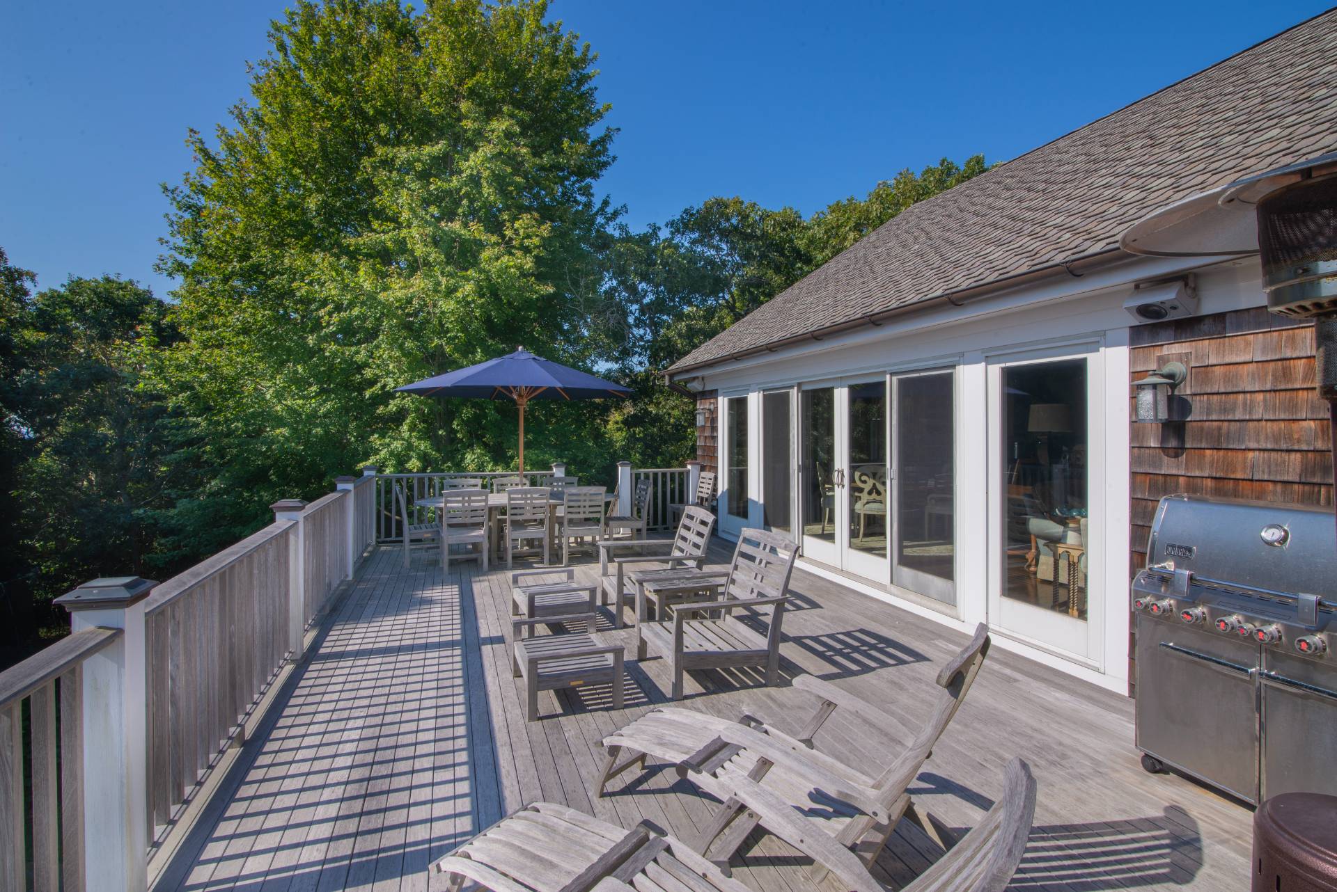 23 Sycamore Lane Montauk, NY 11954 - Photo 8 of 33 a view of a patio with a table chairs and backyard