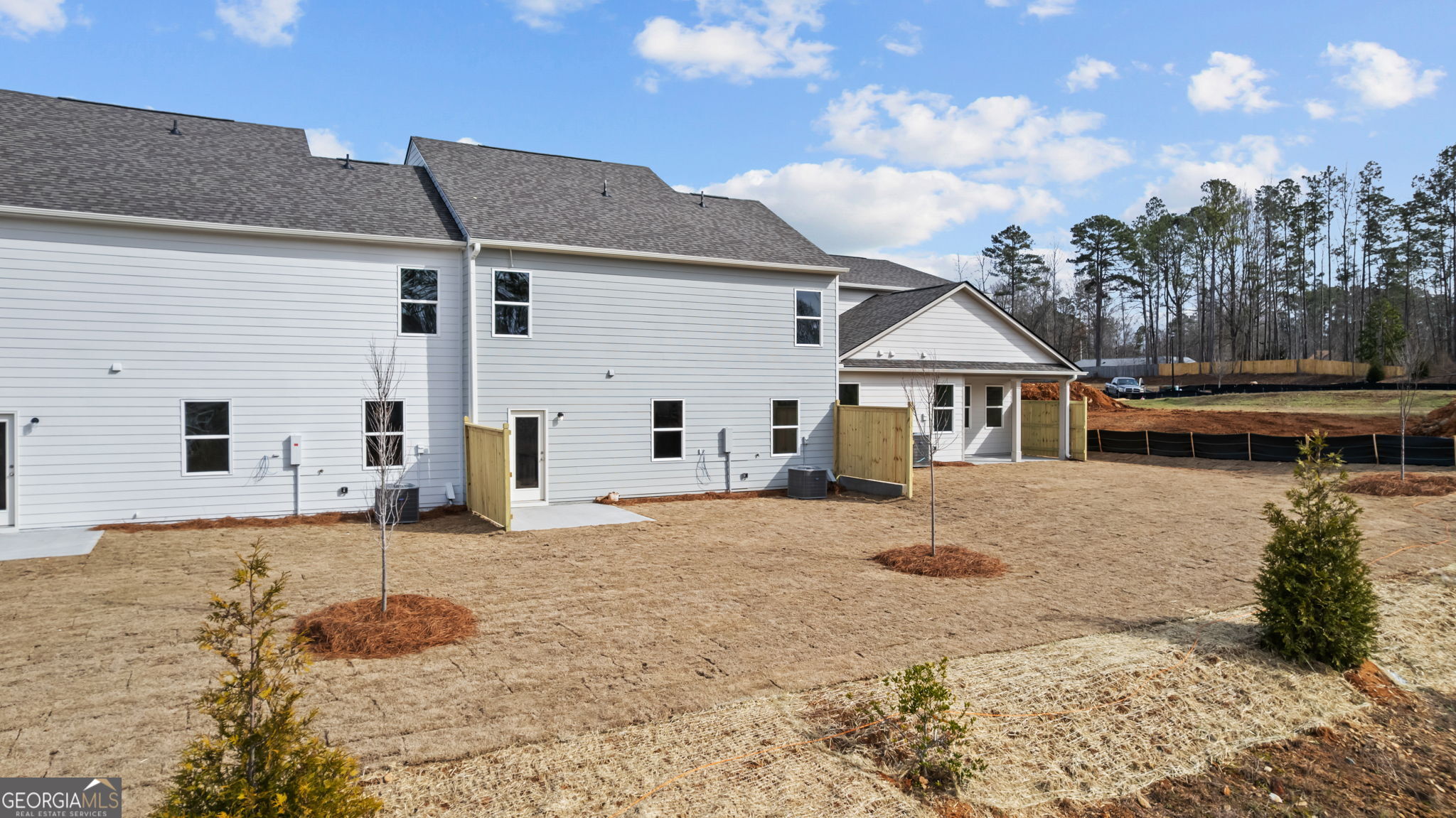 44 Umber Lane Newnan, GA 30263 - Photo 23 of 28 a view of a white house with a yard and wooden fence