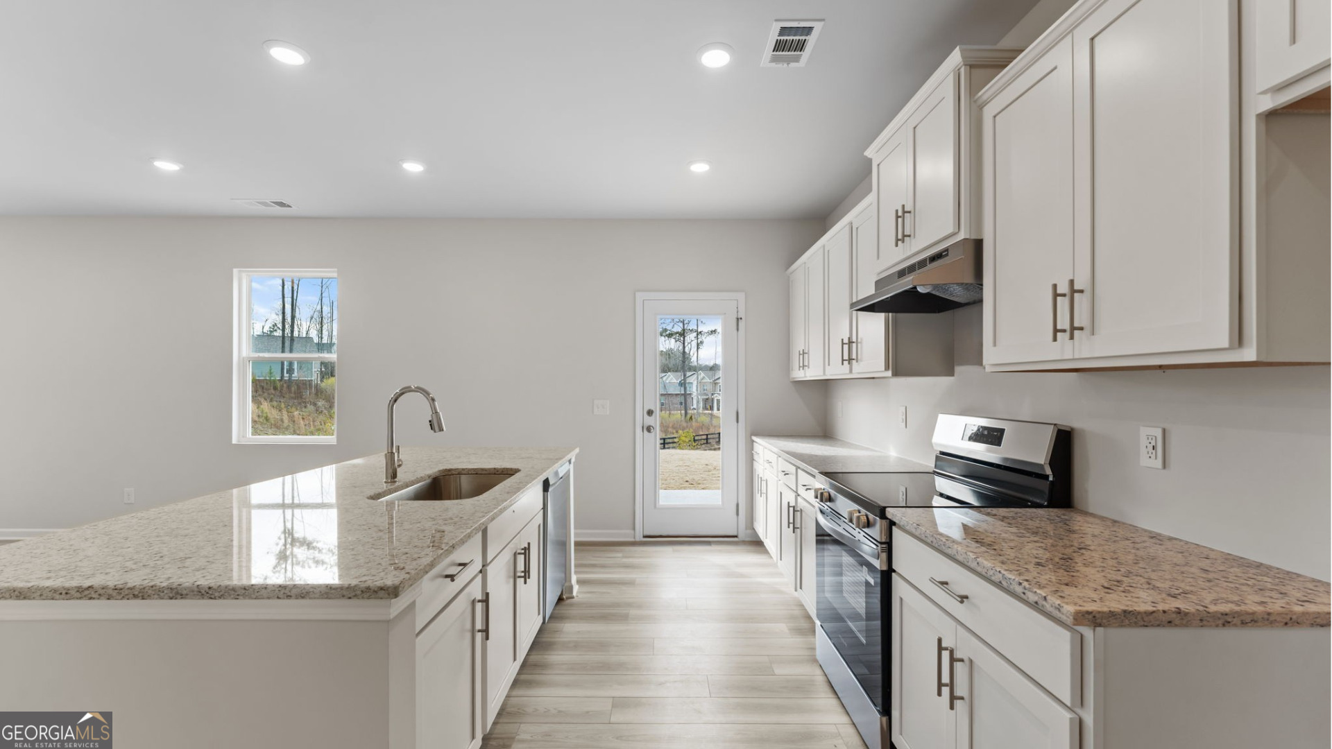 44 Umber Lane Newnan, GA 30263 - Photo 7 of 28 a kitchen with stainless steel appliances granite countertop a sink stove and cabinets