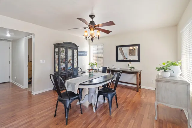 a view of a a dining room with furniture window and wooden floor