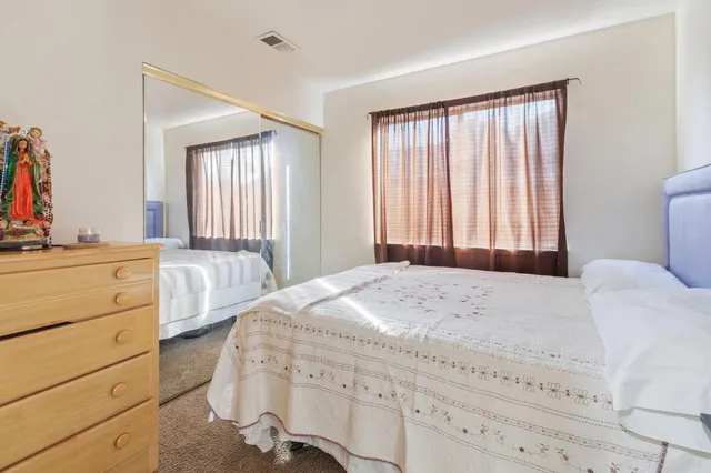 a bedroom with a bed and a dresser