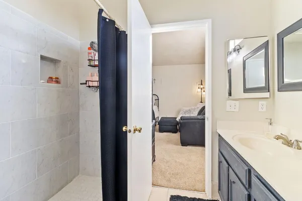 a bathroom with a tub sink and mirror