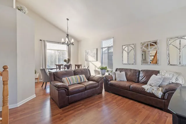 a living room with furniture and a chandelier